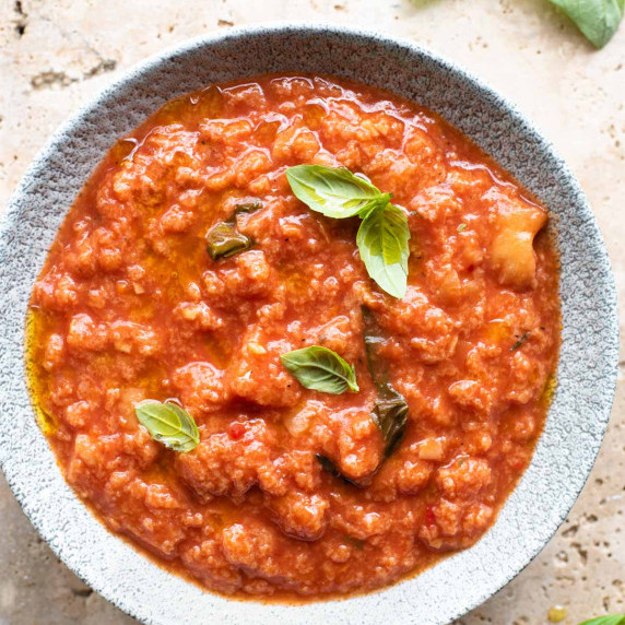 A close up of pappa al pomodoro in a bowl topped with basil