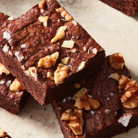 udgy brownies with walnuts and sea salt, featuring a crackled top and deep chocolate color.