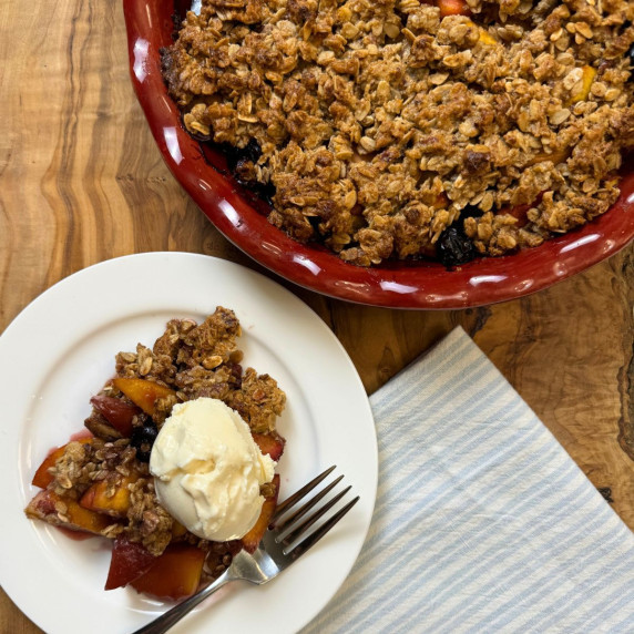 peach blueberry crisp with ice cream ready to serve