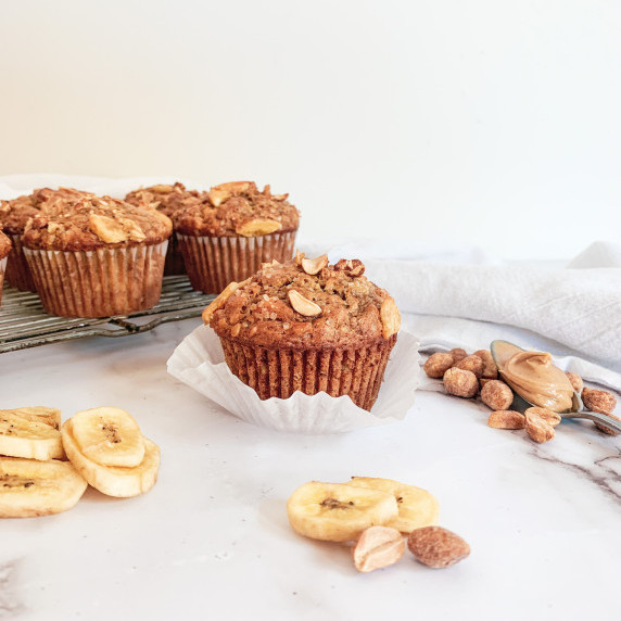 peanut butter banana muffins on a white counter