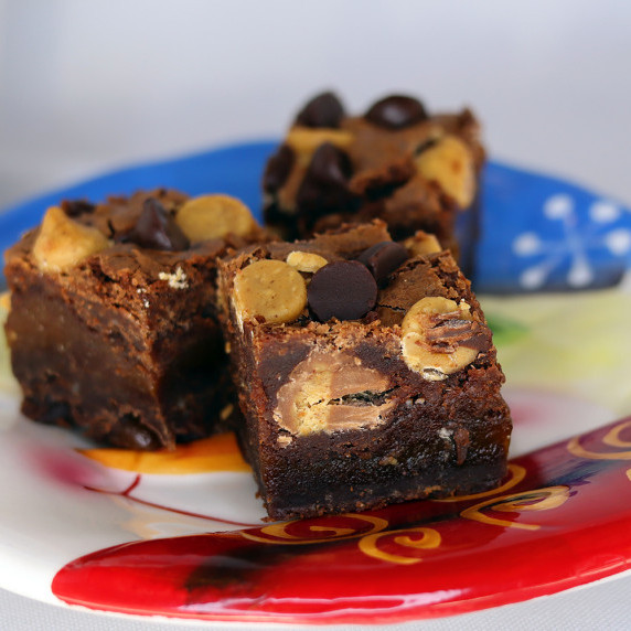 Peanut Butter Cup Caramel Brownies arranged on a holiday plate.