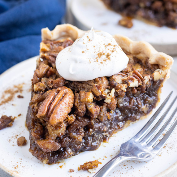 Pecan Pie without Corn Syrup RECIPE served on a white plate with a fork.