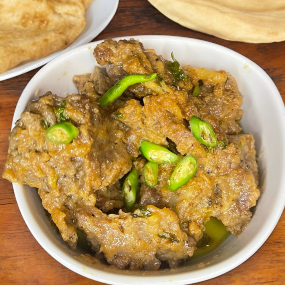 Namkeen gosht arranged in white bowl placed on table