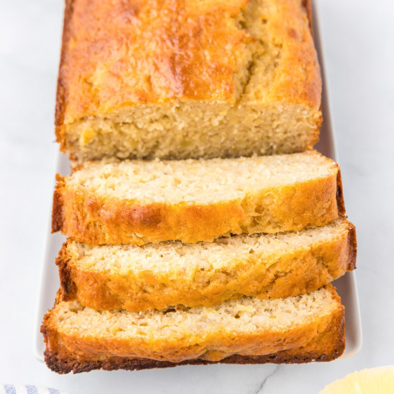 Pineapple banana bread sliced into thick slices from a loaf from above.