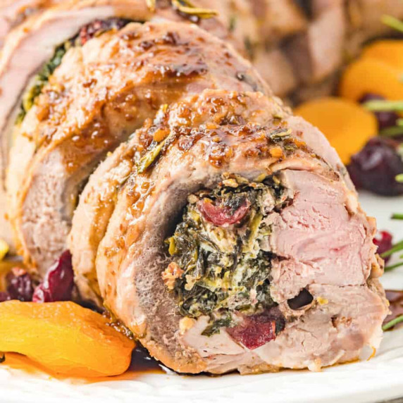Close up of rolled pork tenderloin stuffed with spinach, cheese and dried fruit close up.