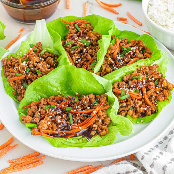 Asian-style ground pork lettuce wraps with ground meat and vegetable filling on a platter.