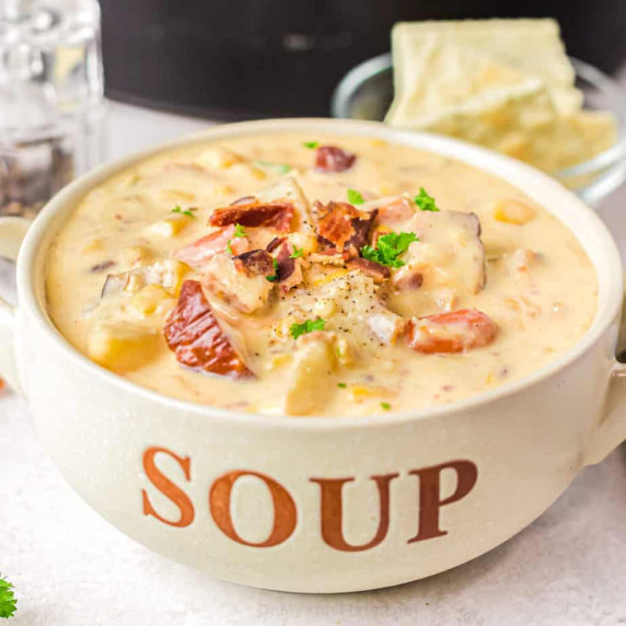 Close up image of potato soup in a bowl labeled soup with bacon on top.