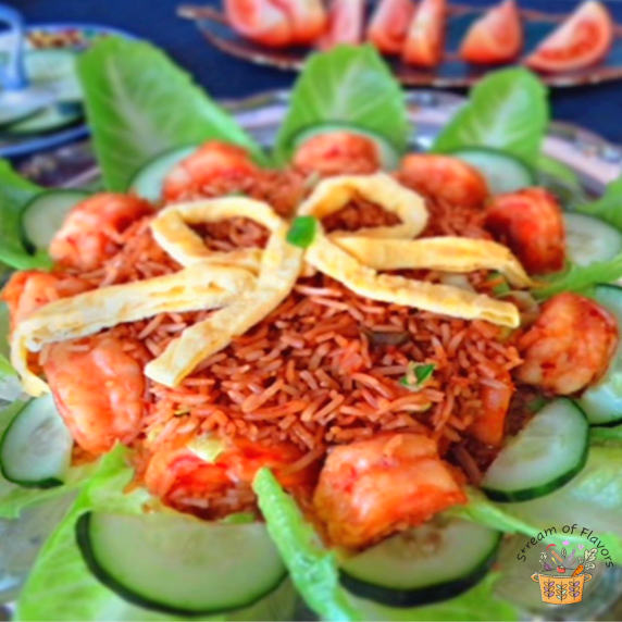Prawn Nasi Goreng in a bed of shrimp, cucumbers, and lettuce topped with egg strips