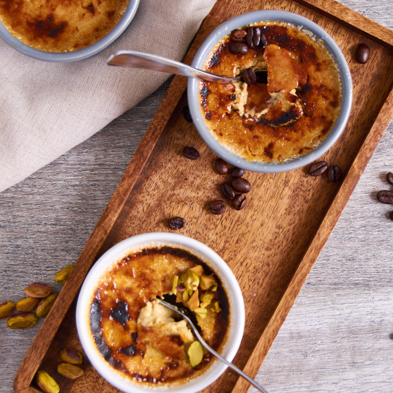 Two versions of Protein Creme Brulee: Coffee and Pistachio. Top cracked with a spoon.