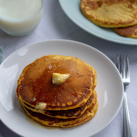stack of pumpkin pancakes on a white plate