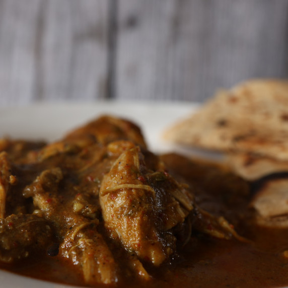 Chicken in curry gravy served with a chapati
