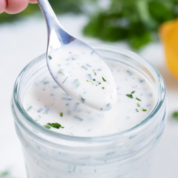 Best Homemade Ranch Dressing RECIPE served in a Mason jar and a silver spoon.