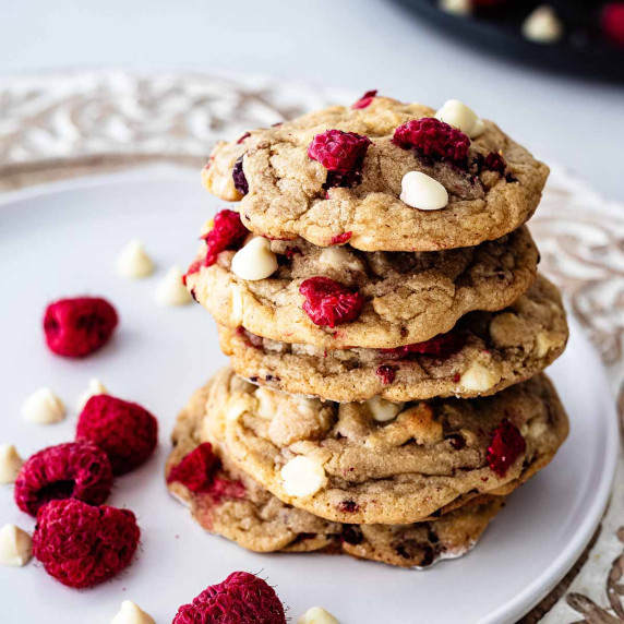 Stack of raspberry white chocolate cookies on a white plate