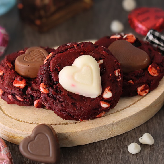 Red velvet sweetheart cookies arranged on a white plate