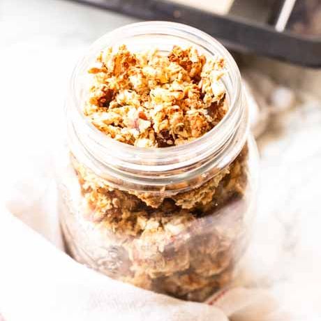 A jar with crunchy homemade granola without oil