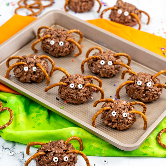 Spider-shaped rice cereal treats with pretzels as legs and edible candy eyes