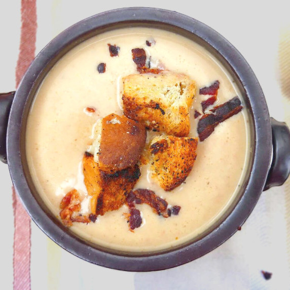 overhead view of a bowl of soup with croutons