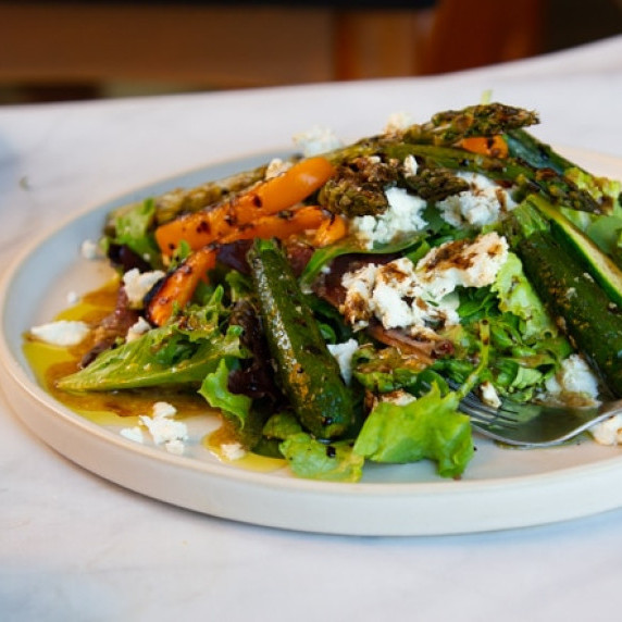 Grilled asparagus and other vegetables, with feta cheese, tomatoes, roasted garlic vinaigrette, and 