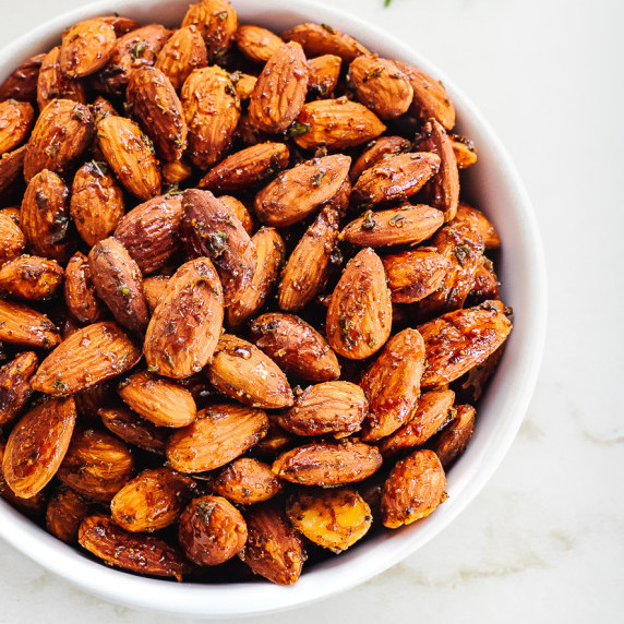 Bowl of roasted and seasoned almonds.