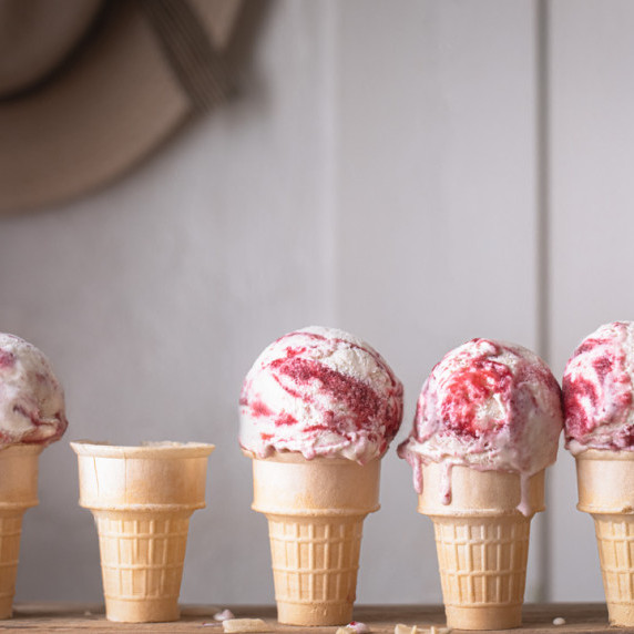 ice cream cones with scoops of strawberry swirl ice cream