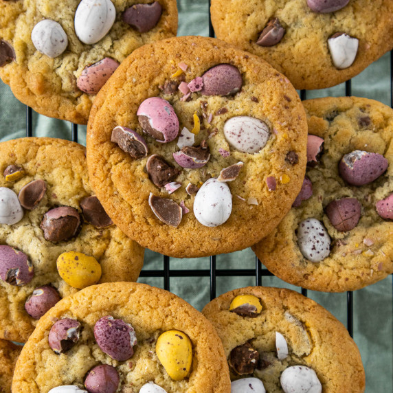 Mini eggs cookies on a wired cooling rack.