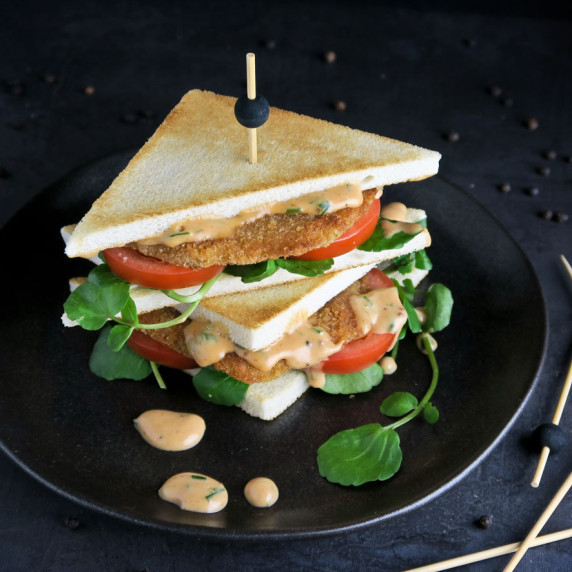 Argentine milanesa sandwich with salsa golf, watercress and tomato