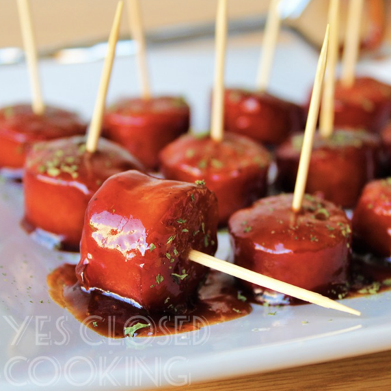 Apricot BBQ Kielbasa Appetizers with toothpicks on a white plate