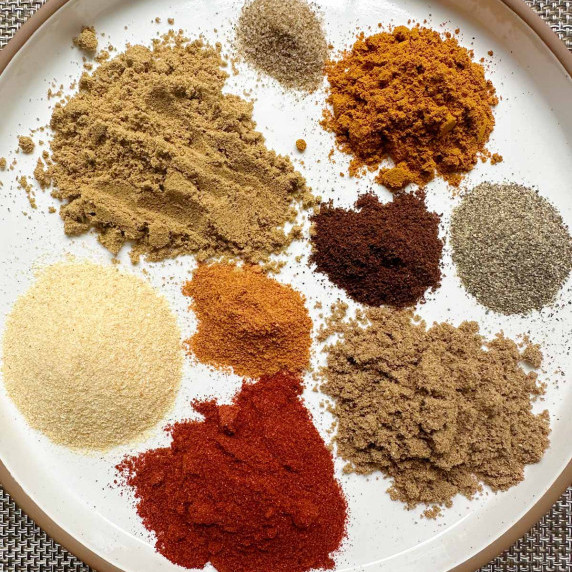 different spices on a white plate