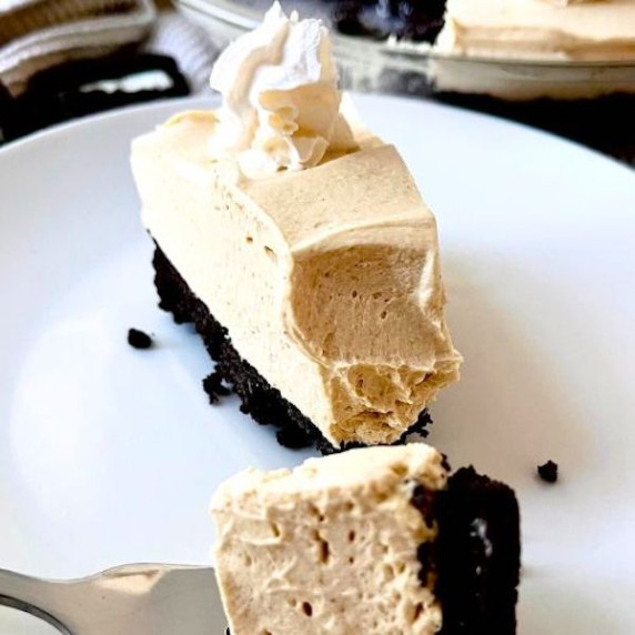Slice of no bake peanut butter pie on a white plate.