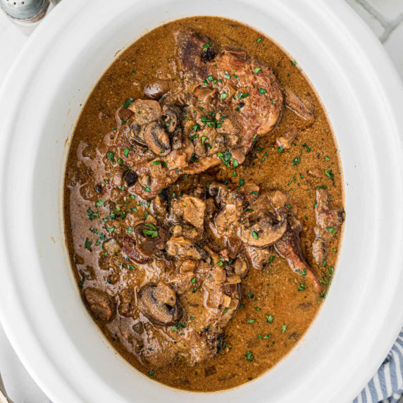 Overhead shot of a slow cooker smothered pork chops recipe.