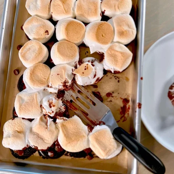 Smoreos arranged on cookie sheet with serving spatula.