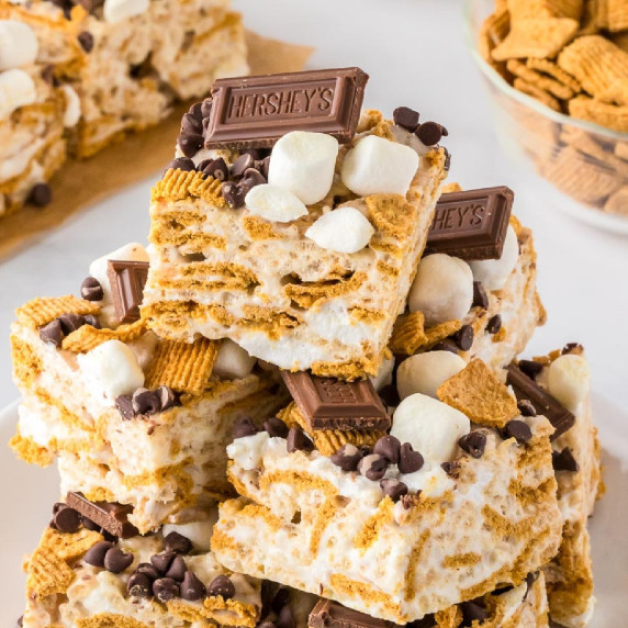 A stack of s'mores Rice Krispie treats topped with chocolate, marshmallows, and Golden Graham's.