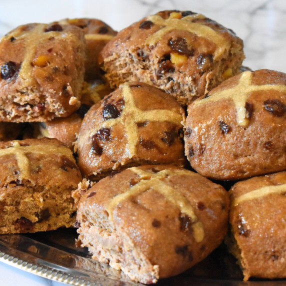 A pile of soft and fluffy hot cross buns on a platter