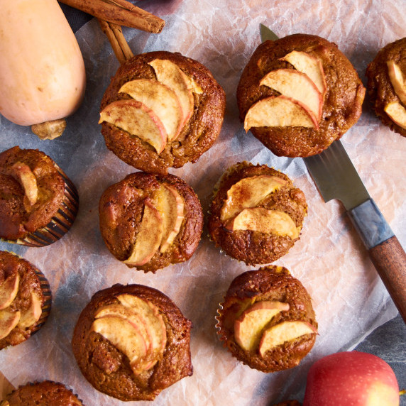 Sourdough Pumpkin Apple Muffins with Protein on a board with baking parchment. 