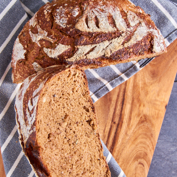 German Sourdough Rye Beer Dutch Oven Bread, cut in half, showing the inside.