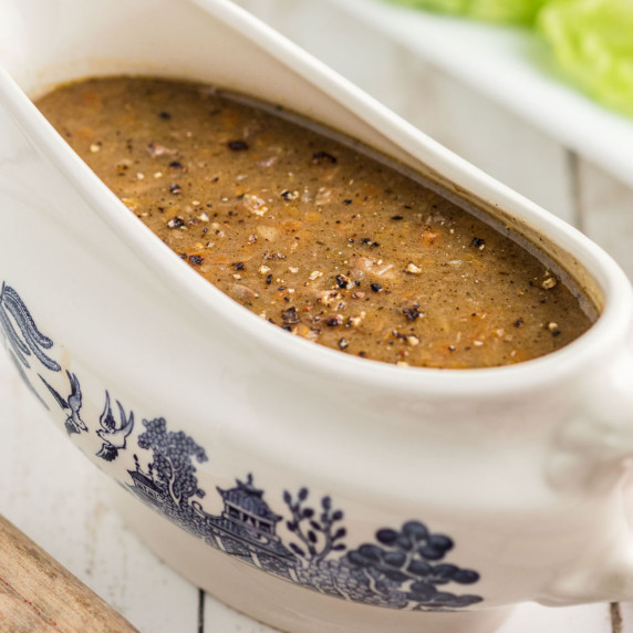 A gravy boat filled with giblet gravy.