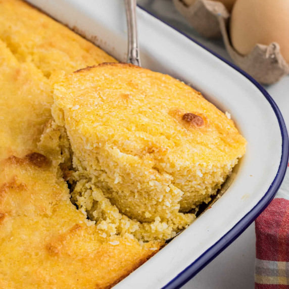 Close up of the corner of a pan of spoon bread.