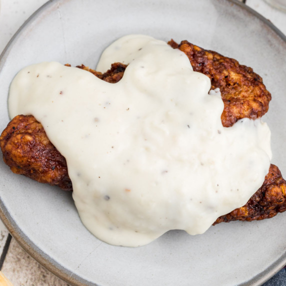 fried pork chop that has a southern white gravy poured over the top.