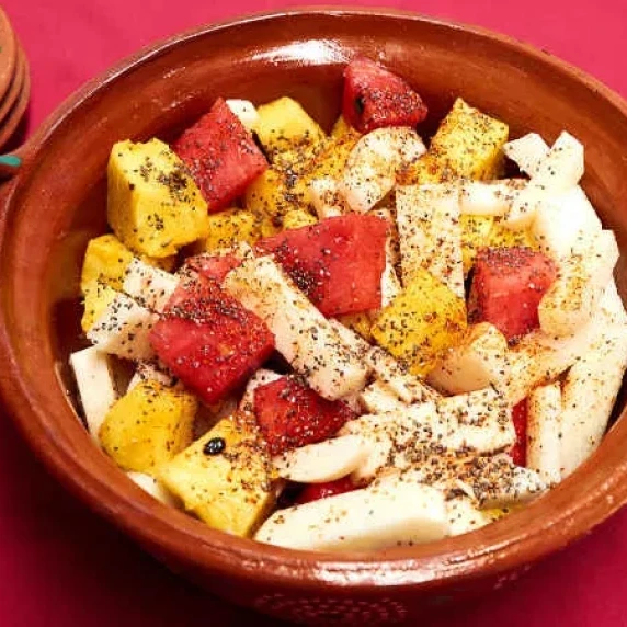 a bowl of spicy mixed fruit salad