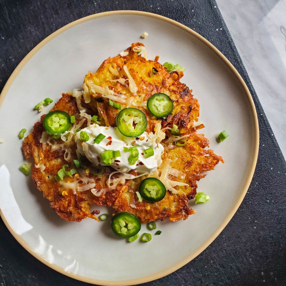 Crispy, golden brown potato pancakes topped with sour cream & fresh garnishes.