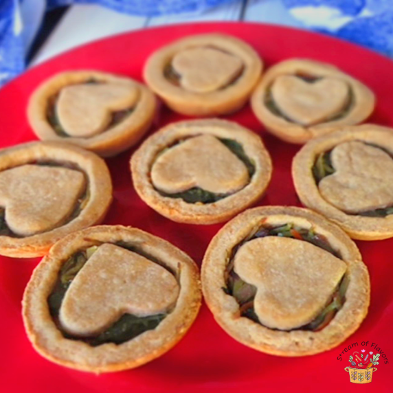 Spinach Pastries Recipe with spinach, carrot, and broccoli stalks in shortcrust pastry on red plate