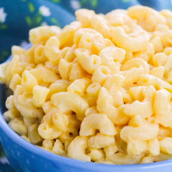 Close-up image of macaroni and cheese in a blue bowl.