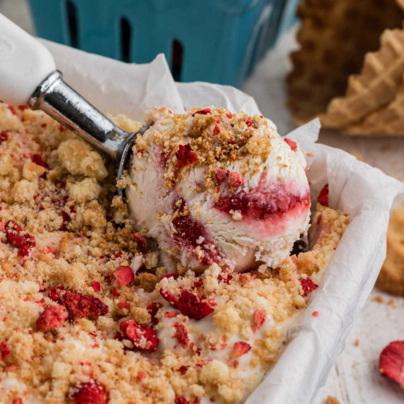 Close up of some strawberry shortcake ice cream being scooped out.