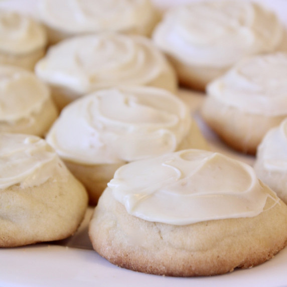 Iced Amish Sugar Cookies on a white plate. 