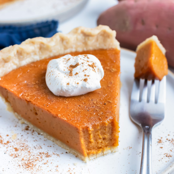 Sweet Potato Pie RECIPE  served on a white plate with a fork.