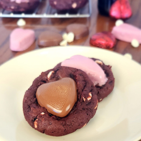 Red velvet sweetheart cookies arranged on a white plate