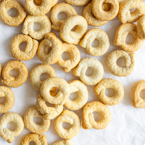 Close-up of homemade taralli, golden ring-shaped Italian crackers, freshly baked and ready to enjoy.