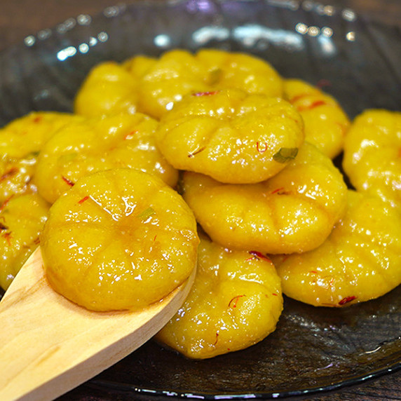 Potatoe and pumpkin gnocchi on a plate.