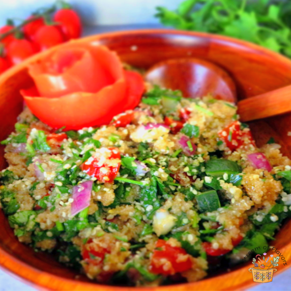 Tabbouleh with Amaranth salad with onion, cucumber and amaranth with a tomato rose in a wooden bowl
