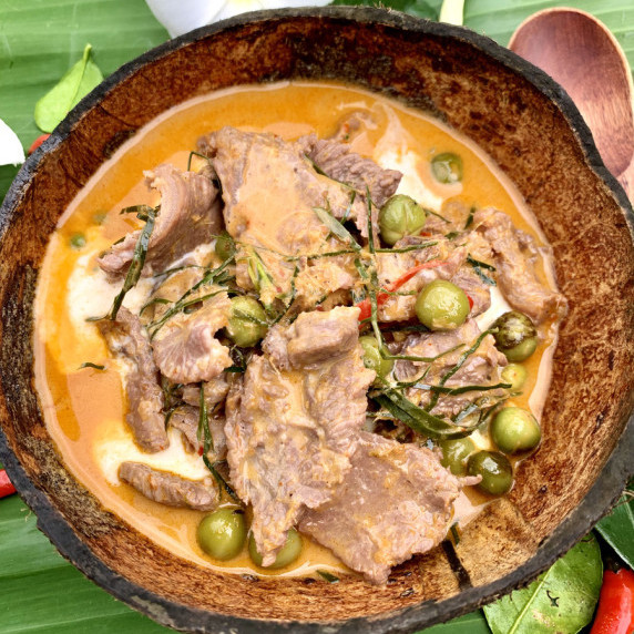 Thai beef panang curry served in a coconut shell.
